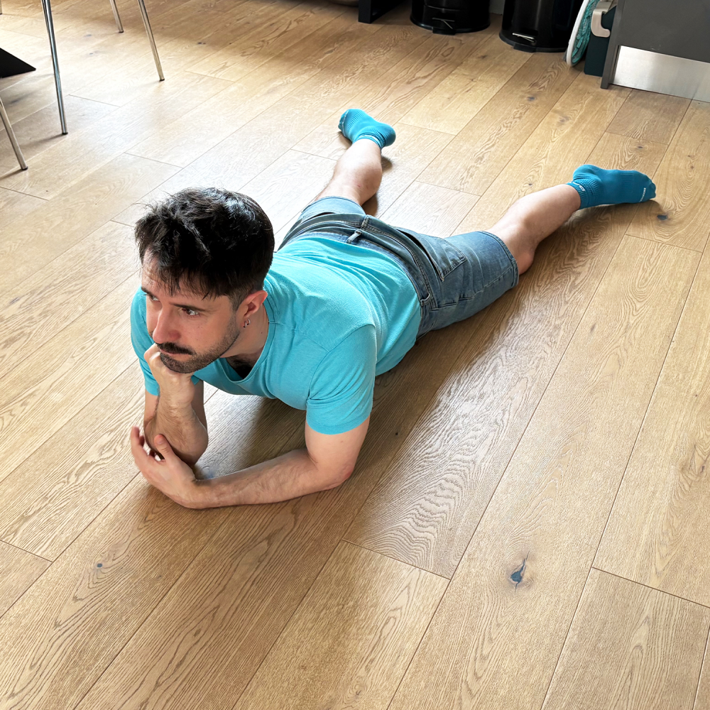 a man lays sprawled on the ground, looking slightly fed up a man lays sprawled on the ground, looking slightly fed up